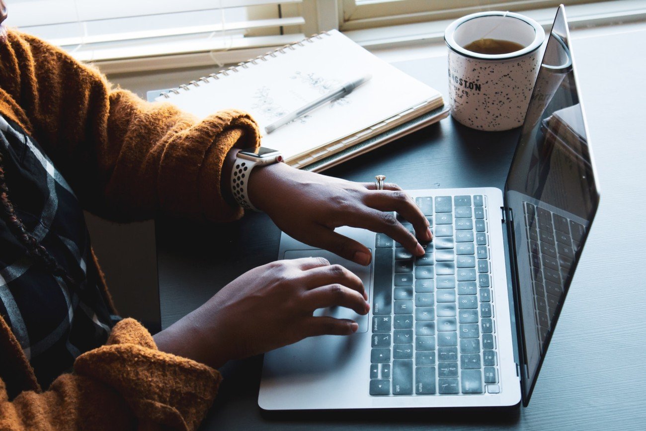 Woman's hands typing on laptop